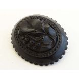 A Whitby jet brooch of oval form with carved  foliate decoration. Approx 2 1/4" high 
 CONDITION: