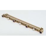 A 10k gold bar brooch set with three amethysts and 3 seed pearls 2 3/8" long  CONDITION: Please Note