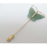 A gilt metal stick pin surmounted by aventurine butterfly decoration. The whole 2 ½” long