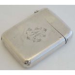 A silver cigarette case of large vesta case form with hinged lid, engraved monogram to one side