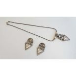 A silver necklace with abstract geometric pendant and rope twist detail together with matching