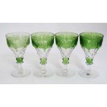 A set of 4 19thC green and clear glass pedestal wine glasses with etched fruiting vine decoration