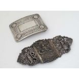 Belt Buckles: A silver plate belt buckle marked made in Gt Britain together with another decorated