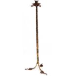 An usual wrought iron candle stand formed as three entwined snakes 48" high  CONDITION: Please