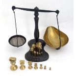 Salter : A pair of cast iron balance scales with brass tray scales and weights and two sets of brass