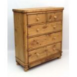 A late Victorian tripped pine chest of drawer comprising 2 short over 2 graduated long drawers