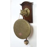 A late 19thC wall mounted brass and stained oak gong and beater held by the head of a lioness 20"