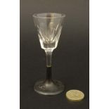 A facet cut liqueur glass with silver pedestal foot hallmarked London 1883 maker Edward Charles