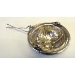 A Continental white metal tea strainer with spout attachment. Indistinctly marked. Approx 2 1/4"