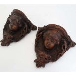 A pair of 19thC terracotta putto wall brackets / sconces, having scrolling acanthus leaf and