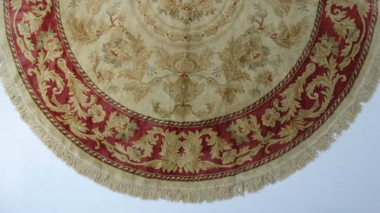 A late 20thC buff ground circular silk rug with rouge border. 84" diameter CONDITION: Please Note - - Image 6 of 7