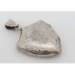 A silver locket pendant of shield form with engraved decoration. Marked 925. Approx 1 ½" long