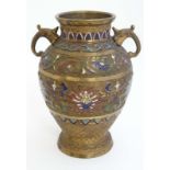 Cloisonné : A Japanese gilded brass vase of ovoid form with Cloisonne decoration and qilin formed