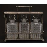 An Atkin Brothers, Sheffield  late 19thC / early 20thC silver plate Tantalus holding three cut glass