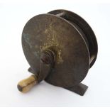 Fishing : an Eaton and Deller brass trotting reel with bone handle, signed 2 3/4" diameter.