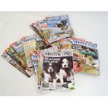 A large collection of approximately 30 copies of '' Shooting Times '' for 2009/2010, published by
