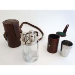 Shooting : A cased set of three shaped decanters , each 7" tall , together with a cased set of