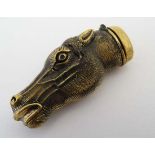 A novelty brass vesta case formed as a horse's head with hinge lid and striker to end. 2 ½” long.