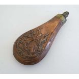 Muzzleloading : A 19thC copper powder flask , the body decorated to both sides with hunter and