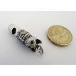 A Sterling novelty whistle with cats head decoration and set with green stones to eyes and