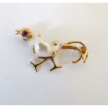 A yellow metal brooch formed as a stylised pheasant set with blister pearl to body and red stone