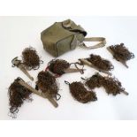 A military surplus canvas bag containing a quantity of ferreting nets , approximately 11"