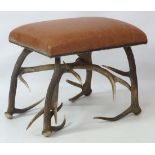 Taxidermy :  a Scottish  Red Deer Antler Stool with upholstered leather seat held by ornate headed