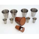 Two sets of spirit cups consisting of a set of four stainless steel cups (each 3 ¼” x 3 3/8”  ) in a