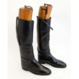 Equestrian: A pair of black leather  riding / hunting boots with garter straps and wooden boot