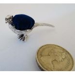 A novelty white metal pin cushion formed as a pheasant. Approx. 2” long CONDITION: Please Note -  we