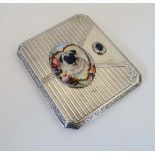 A Continental silver cigarette case with stone cabochon to clasp and later applied oval ceramic