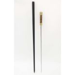 Collectors Sword Stick : 
A c 1900 and later brass topped  cane with ebonised shaft, the handle