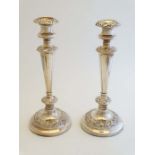 A pair of silver plate candlesticks with acanthus, floral and C-scroll decoration 11 1/2" high