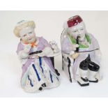 A pair of 19thC majolica style figural tobacco jars , one formed as a seated old lady drinking tea