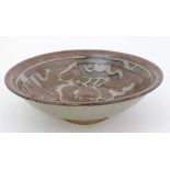 A Studio Pottery '' Slip Ware '' bowl . With brown glaze and mottled grey slip decoration.