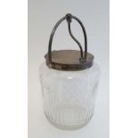 WMF : A cut glass biscuit barrel  with silver plated mounts and lid, the handle opening the hinged