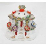 A 19thC cottage pastille burner, the round cottage having central steps, large applied flowers and