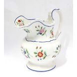 A 19th century hand painted Staffordshire jug. Decorated with floral sprays with blue edging and