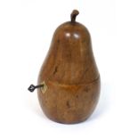 A 20thC pear wood carved pear formed tea caddy with shield shaped escutcheon and key . 7 1/2"