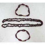 A garnet bead necklace approx 32" long, together with 2 garnet bead bracelets. (3) CONDITION: Please