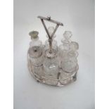 A silver plate 6 bottle cruet stand by HG Long & Co . The stand of ovoid form with shield to sides