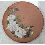 An early 20th C Watcombe Torquay charger. Decorated with white roses on a terracotta ground.