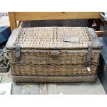 A c.1900 wicker laundry hamper with leather straps and leather ends, brass lock and rope handles.