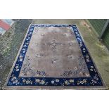 Rug / Carpet : A Chinese woollen carpet with floral decoration,  blue banded border and mushroom