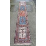 Rug / Carpet :   A long Turkish woollen runner, with 5 distinct central sections in salmon pink,