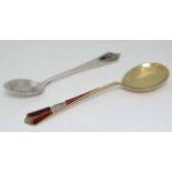 A Norwegian sterling silver gilt teaspoon with guilloche enamel decoration, by David Andersen.