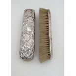 2 Victorian silver backed brushes with embossed decoration  CONDITION: Please Note -  we do not make