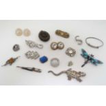 A quantity of assorted jewellery to include various pendants , brooches etc  CONDITION: Please