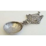 A Continental silver caddy spoon with windmill decoration to bowl and ship formed handle. Bears