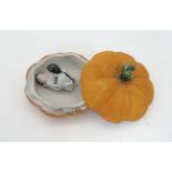 A novelty ceramic pumpkin formed pot and cover opening to reveal risqué scene within. 
 CONDITION: